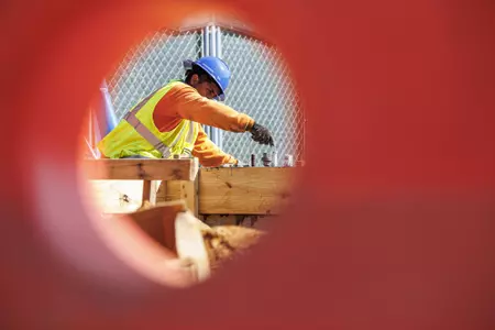 STARKVILLE, MS - September 22, 2022 - Construction workers finish the new concrete slab during construction at the MSU Softball Indoor Facility at Mississippi State University in Starkville, MS. Photo By Kevin Snyder