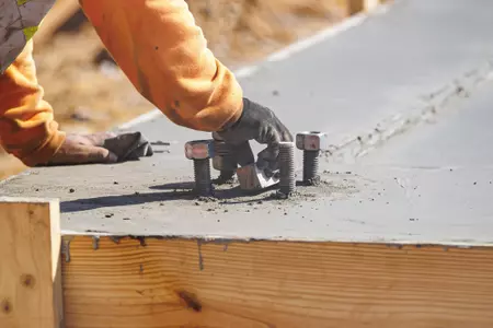STARKVILLE, MS - September 22, 2022 - Construction workers finish the new concrete slab during construction at the MSU Softball Indoor Facility at Mississippi State University in Starkville, MS. Photo By Kevin Snyder