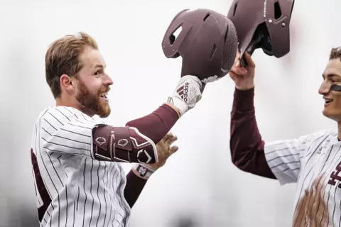 STARKVILLE, MS - February 27, 2022 - Mississippi State Infielder Luke Hancock (#20) and Mississippi State Infielder Kamren James (#6) celebrate during the game between the Northern Kentucky Norse and the Mississippi State Bulldogs at Dudy Noble Field at Polk-Dement Stadium in Starkville, MS. Photo By Austin Perryman