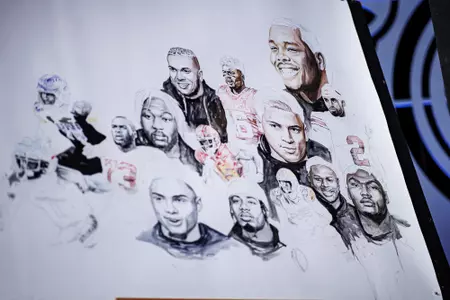 LAS VEGAS, NV - April 28, 2022 - Mississippi State Offensive Lineman Charles Cross is painted onto a poster before the 2022 NFL Draft at Caesars Forum in Las Vegas, NV. Photo By Austin Perryman