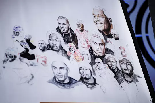 LAS VEGAS, NV - April 28, 2022 - Mississippi State Offensive Lineman Charles Cross is painted onto a poster before the 2022 NFL Draft at Caesars Forum in Las Vegas, NV. Photo By Austin Perryman