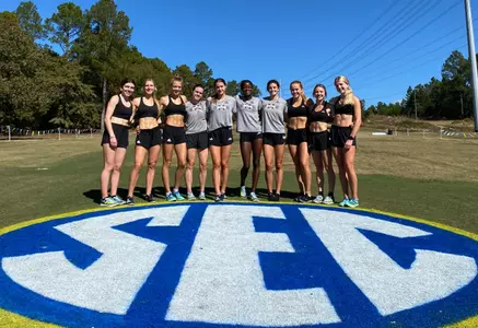 Team poses by the SEC logo before the SEC Championship