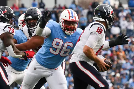 Dec 17, 2023; Nashville, Tennessee, USA; Houston Texans quarterback Case Keenum (18) is sacked by Tennessee Titans defensive end Denico Autry (96) during the second half at Nissan Stadium. Mandatory Credit: Christopher Hanewinckel-USA TODAY Sports