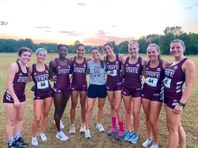 Cross Country runners posing after placing second overall at the opener