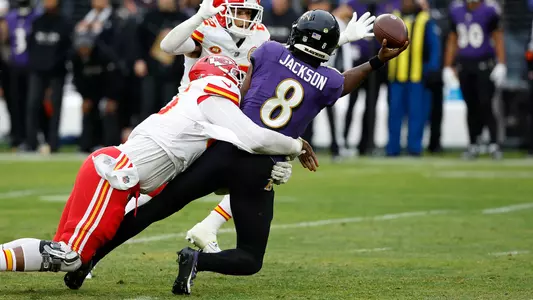 Jan 28, 2024; Baltimore, Maryland, USA; Baltimore Ravens quarterback Lamar Jackson (8) throws the ball around Kansas City Chiefs cornerback Trent McDuffie (22) while being sacked by Chiefs defensive tackle Chris Jones (95) during the first half in the AFC Championship football game at M&T Bank Stadium. Mandatory Credit: Geoff Burke-USA TODAY Sports