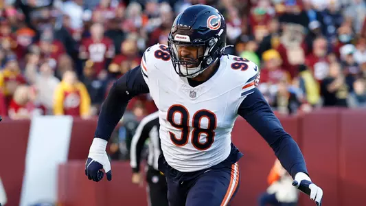 Oct 27, 2024; Landover, Maryland, USA; Washington Commanders quarterback Jayden Daniels (5) runs with the ball as Chicago Bears defensive end Montez Sweat (98)chases during the first quarter at Northwest Stadium. Mandatory Credit: Geoff Burke-Imagn Images