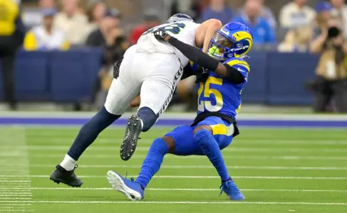 Jan 5, 2025; Inglewood, California, USA; Los Angeles Rams cornerback Emmanuel Forbes Jr. (25) stops Seattle Seahawks tight end AJ Barner (88) after a first down in the second half against at SoFi Stadium. Mandatory Credit: Jayne Kamin-Oncea-Imagn Images