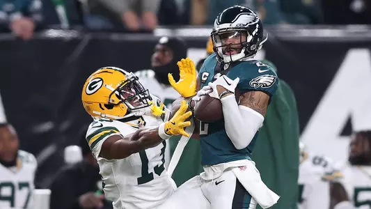 Jan 12, 2025; Philadelphia, Pennsylvania, USA; Philadelphia Eagles cornerback Darius Slay Jr. (2) makes an interception against Green Bay Packers wide receiver Dontayvion Wicks (13) during the first half in an NFC wild card game at Lincoln Financial Field. Mandatory Credit: Bill Streicher-Imagn Images