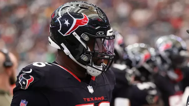 Nov 9, 2025; Houston, Texas, USA; Houston Texans defensive end Denico Autry (96) talks with umpire Terry Killens (77) during the second half of a game against the Jacksonville Jaguars at NRG Stadium. Mandatory Credit: Thomas Shea-Imagn Images