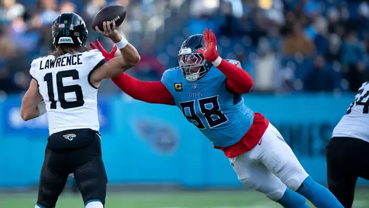 Tennessee defensive tackle Jeffery Simmons (98) hits the chest of Jacksonville quarterback Trevor Lawrence (16) to alter his third-down throw during their game at Nissan Stadium Sunday, Nov. 30, 2025. Jacksonville was forced to punt.