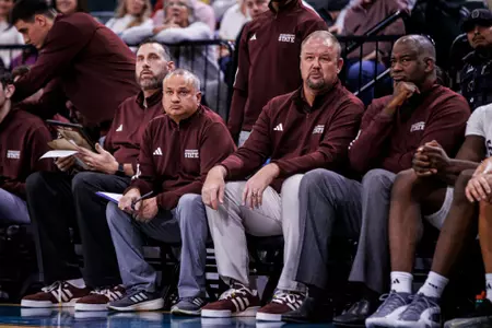 TUPELO, MS - December 14, 2024 - Mississippi State's Assistant to the Head Coach Scott Padgett, Mississippi State Assistant Coach David Anwar, Mississippi State Associate AD/Men's Basketball Doug Wagemester and Mississippi State Assistant Coach George Brooks during the game between the McNeese State Cowboys and the Mississippi State Bulldogs at Cadence Bank Arena in Tupelo, MS. Photo By Mike Mattina