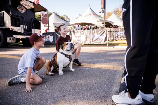 STARKVILLE, MS - October 26, 2024 - Kids with Mississippi State Live Mascot Dak during the game between the Arkansas Razorbacks and the Mississippi State Bulldogs at Davis Wade Stadium at Scott Field in Starkville, MS. Photo By Ivy Rose Ball
