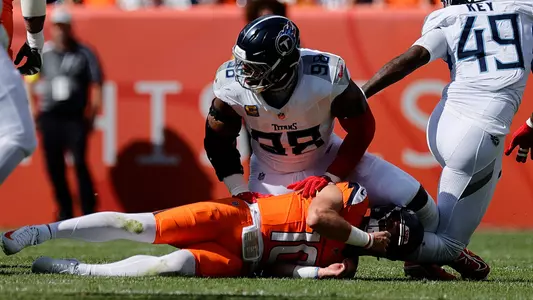 Sep 7, 2025; Denver, Colorado, USA; Tennessee Titans defensive tackle Jeffery Simmons (98) sacks Denver Broncos quarterback Bo Nix (10) in the first half at Empower Field at Mile High. Mandatory Credit: Isaiah J. Downing-Imagn Images