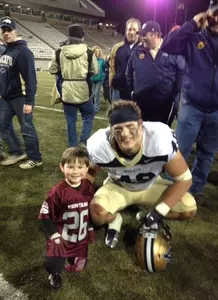 Caleb Schreibeis with griz kid