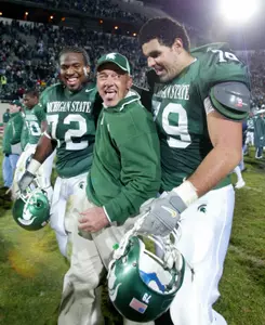 John L. Smith celebrates with Stefon Wheeler and Sean Poole following a 49-14 win over fourth-ranked Wisconsin.
