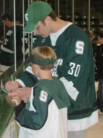 Matt Migliaccio signs an autograph for a young Spartan fan at last year's Skate with the Spartans.