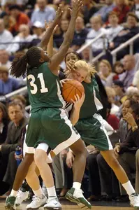 Victoria Lucas-Perry, left, and Rene Haynes, right, team up to box in Connecticut's Nicole Wolff as Wolff tried to bring the ball down the court.