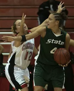 Kristin Haynie is defended by Cincinnati guard Micah Harvey in the first half.