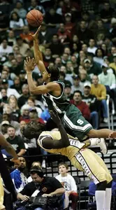 Shannon Brown tries to shoot over George Washington's Pops Mensah-Bonsu, bottom, during the second half of a game in the BB and T Classic, Saturday.