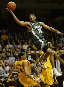 Maurice Ager shoots a layup after splitting the defense of Minnesota guard Brent Lawson and Aaron Robinson in the first half.