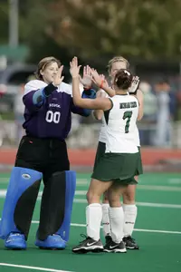 Seniors Christina Kirkaldy and Breanna Harpstead exchange high-fives before a game.
