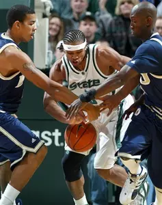 Shannon Brown drives between FIU's Kenny Simms, left and Ismael N'Diaye, right. (AP Photo/Al Goldis)