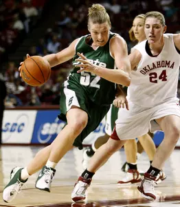 Liz Shimek (52) dribbles past Oklahoma forward Leah Rush. (AP Photo)