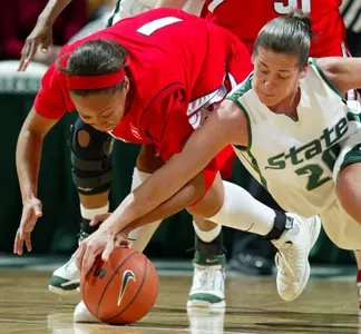 Detroit's Kandace Evans and Lindsay Bowen dive for a loose ball during the first half.