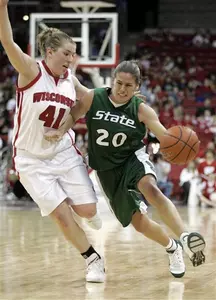 Lindsay Bowen dribbles around Wisconsin's Jolene Anderson during the first half.
