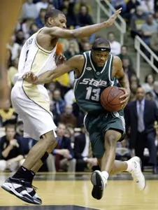 Maurice Ager holds off Purdue's David Teaque as he drives the lane during the first half.