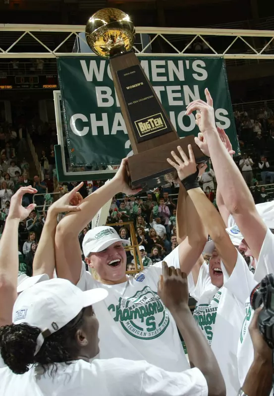 Michigan State players hold up the Big Ten championship trophy after their 77-34 win over Michigan to clinch at least a share of the title.