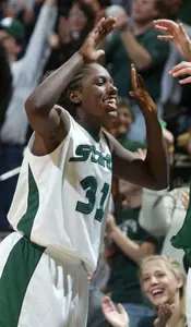 Victoria Lucas-Perry celebrates with teammates on the bench.
