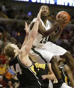 Iowa's Greg Brunner tries to stop Michigan State's Kelvin Torbert (23) from driving to the basket.