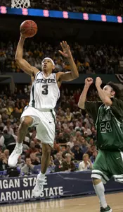 Shannon Brown takes the ball to the basket in front of Vermont's David Hehn.