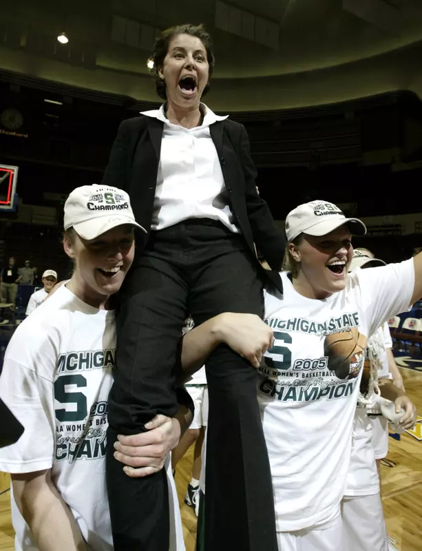Joanne McCallie is carried off the court by Liz Shimek, left, and Kelli Roehrig.