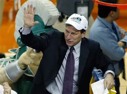 Michigan State coach Tom Izzo waves after he cut down the net at the NCAA Austin Region final at the Frank Erwin Center in Austin, Texas Sunday, March 27, 2005. Michigan State beat Kentucky 94-88 in double overtime.