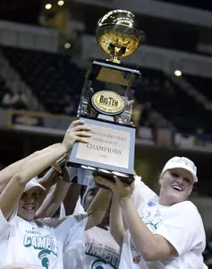 Kristin Haynie and Kelli Roehrig hold the championship trophy after the Spartans defeated Minnesota 55-49 in the championship game of the Women's Big Ten Tournament.