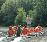 Senior rower Kirsten Rasanen teaches Lansing children how to row.