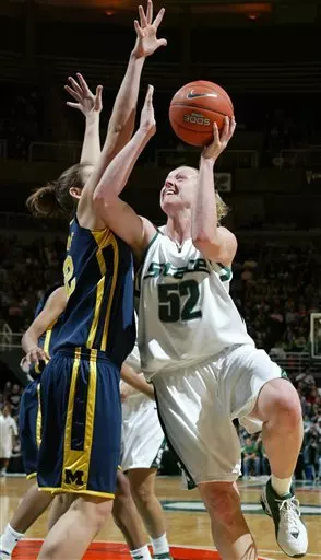Michigan State's Liz Shimek (52) puts up a shot against Michigan's Katie Dierdorf during the first half of a college basketball game, Sunday, Jan. 1, 2006, in East Lansing, Mich. Shimek led Michigan State with 16 points in a 77-44 win. (AP Photo/Al Goldis)
