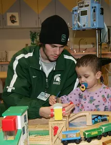 Junior captain Drew Miller spends one night a week, visiting with children at, Sparrow Hospital.