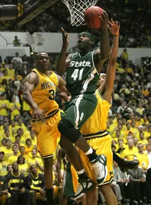 Marquise Gray drives past Michigan defenders in the first half.