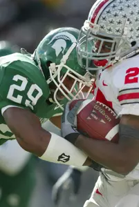 Michigan State's Greg Cooper (29) stops Ohio State's Antonio Pittman during the first quarter. (AP Photo/Al Goldis)