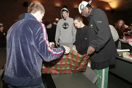 Members of the Michigan State men's basketball team wrap presents for Teams For Toys.