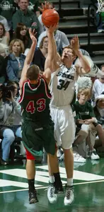Drew Naymick blocks a shot by Wisconsin-Green Bay's Mike Schachtner during the first half Saturday in East Lansing.