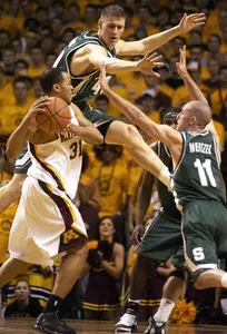 Paul Davis, left, and Drew Neitzel attempt to block the passing lane of Minnesota's Adam Boone during the first half.
