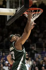 Michigan State's Shannon Brown scores over Northwestern's Vince Scott during first half. (AP Photo/M. Spencer Green)