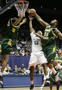 Michigan State's Maurice Ager goes up for a basket against George Mason's Gabe Norwood, left, and forward Jai Lewis during the first half. (AP Photo/Al Behrman)