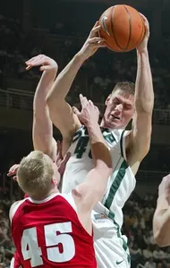 Michigan State's Paul Davis, right, pulls down a rebound over Wisconsin's Joe Krabbenhoft (45) during the first half. (AP Photo/Al Goldis)