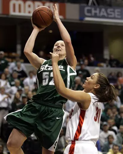 Michigan State's Liz Shimek, left, gets 2 of her 23 points over Ohio State's Debbie Merrill during the second half of a semi-final basketball game in the Big Ten Conference tournament in Indianapolis, Sunday, March 5, 2006. Ohio State defeated Michigan State, 68-64. (AP Photo/Michael Conroy)