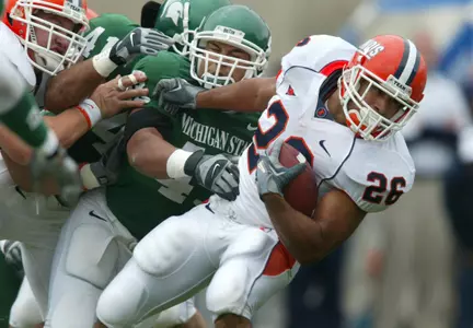 Illinois' E.B. Halsey is tackled by Michigan State's Kaleb Thornhill during the first quarter.
